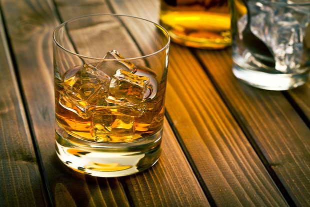 bigstock-whiskey-in-glass-with-ice-on-w-59111945