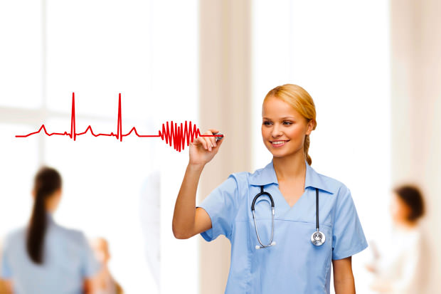 smiling doctor or nurse drawing electrocardiogram
