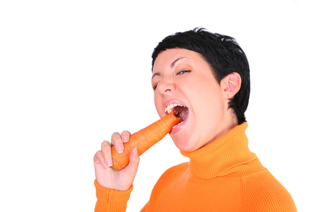 Funny woman with a carrot