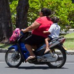 Mother and Daughter Riding Motor Bike