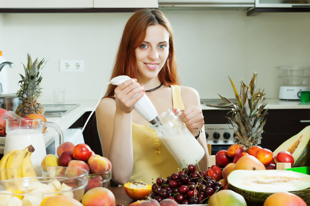 woman cooking milkshake with fruits