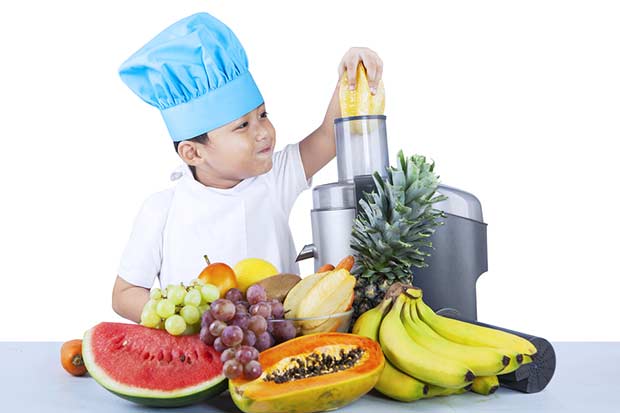 bigstock-Cute-Boy-Is-Making-Fruit-Juice-49690457