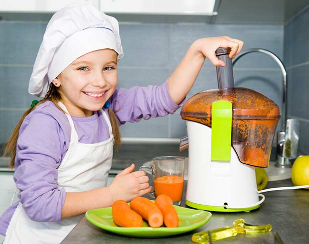 bigstock-little-girl-making-carrot-juic-41734093