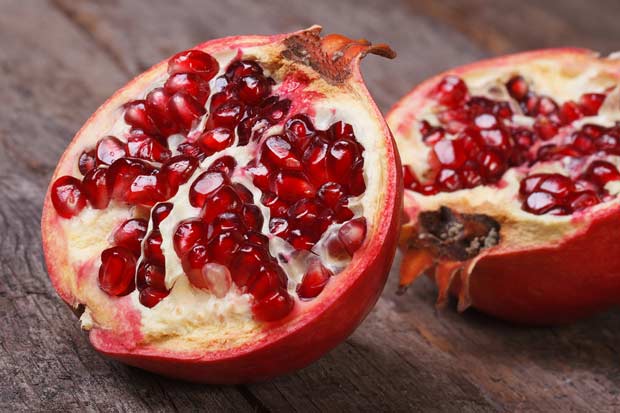 bigstock-Cut-Ripe-Pomegranate-On-An-Old-57706613