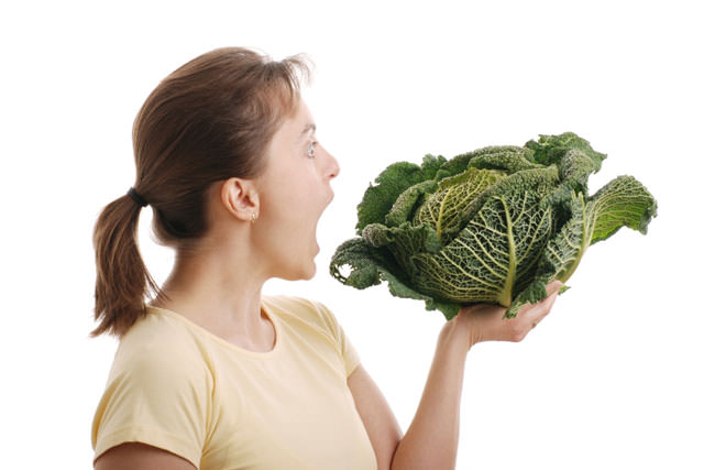 Woman wanting to eat savoy cabbage - isolated