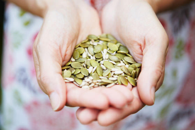 Woman Holding A Handful Of Healthy Seeds