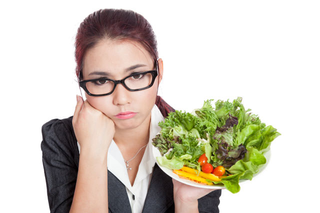 Asian business woman bored with salad bowl