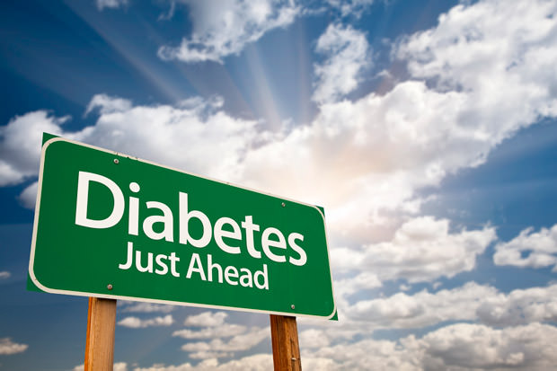 Diabetes Just Ahead Green Road Sign with Dramatic Clouds, Sun Rays and Sky.