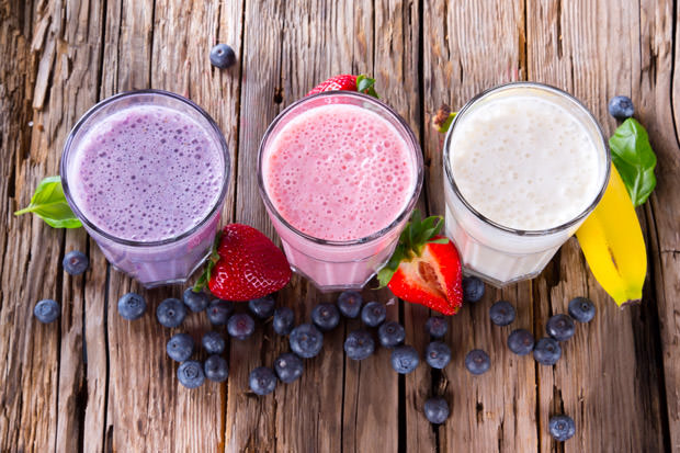 Fresh fruits milk shake on wood