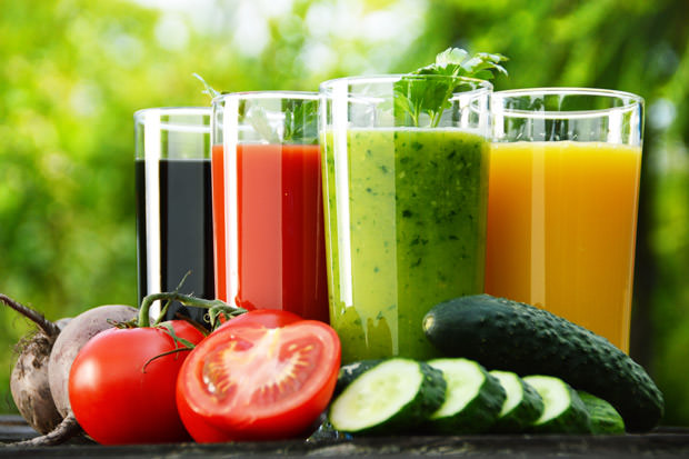 Glasses with fresh vegetable juices in the garden. Detox diet