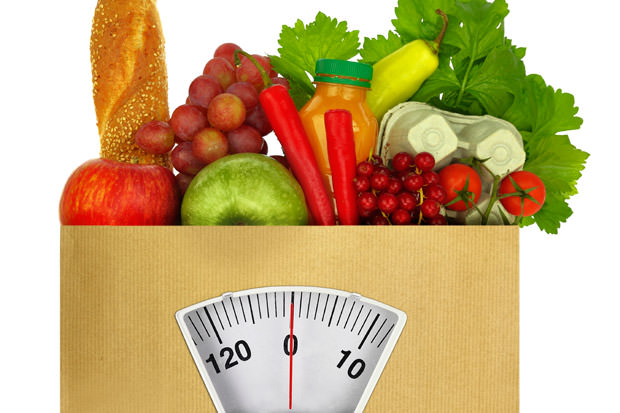 Paper bag full of groceries with weighing scale