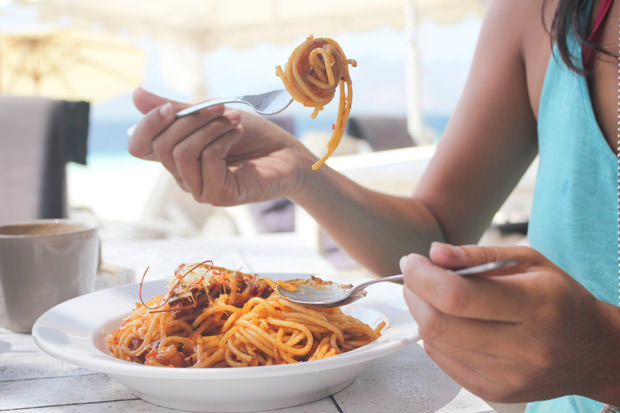 Woman eating pasta