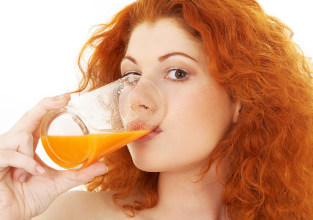 lovely redhead drinking orange juice