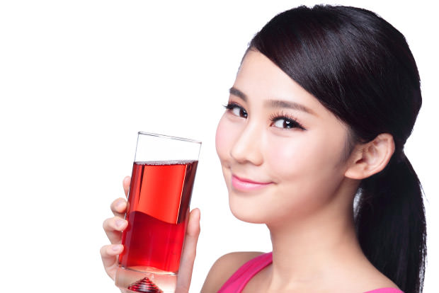 Young happy woman drink juice